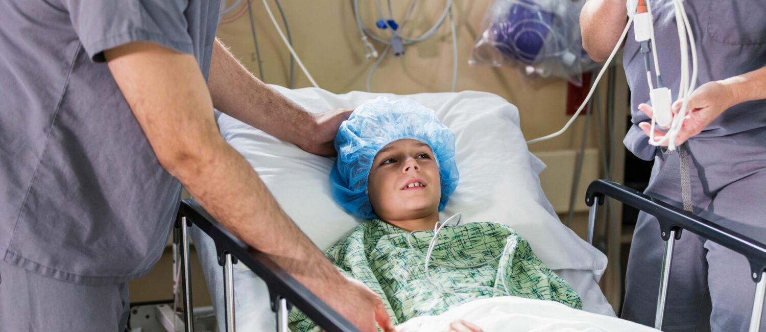 Young kid in a hospital bed getting ready for surgery.