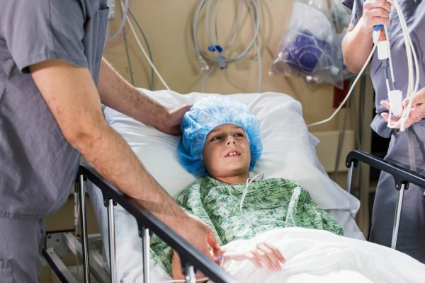 Young kid in a hospital bed getting ready for surgery.