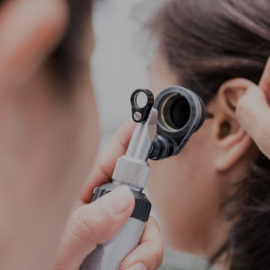 Doctor looking to a patients ear.