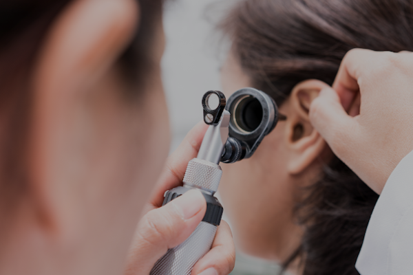 Doctor looking to a patients ear.